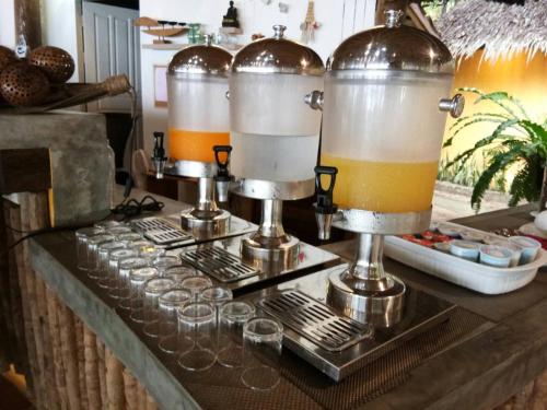 a bar with wine glasses and a bunch of drinks at The Tropical Beach Resort in Ko Chang