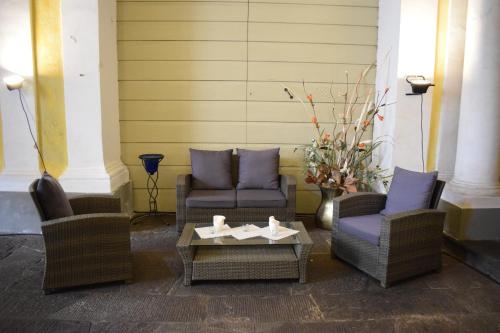 a group of chairs and a coffee table in a porch at Palazzo Tucci Residenza d'epoca in Lucca