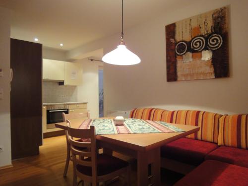 a kitchen and dining room with a table and a couch at Appartementhaus Maria in Radstadt