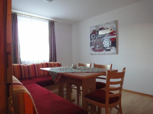 a living room with a table and a couch at Appartementhaus Maria in Radstadt