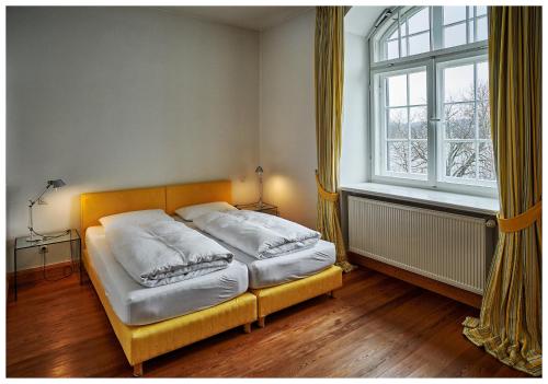 a bed in a room with a large window at Landhaus Stöcker in Feldberg