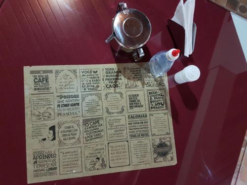 a newspaper taped to a wall with a bottle of water at Pousada Recanto das Águas in Lumiar