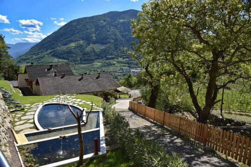 a house with a swimming pool and a fence at Residence Blumenthalerhof in Lagundo