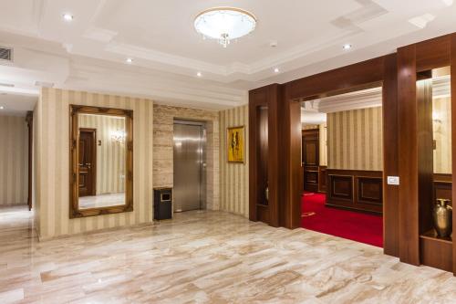 a large room with a large mirror and a hallway at Classic Hotel Prizren in Prizren