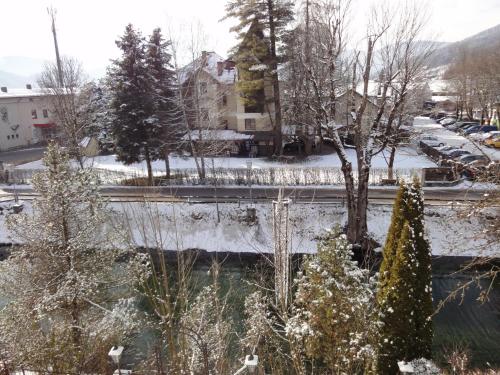 a winter view of a city with snow covered trees at Appartementhaus Maria in Radstadt