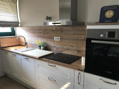 a kitchen with a sink and a stove top oven at Downtown Accommodation 2BR in Zadar