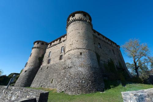 a large castle with two towers on a hill at Castello Di Compiano Hotel Relais Museum in Compiano