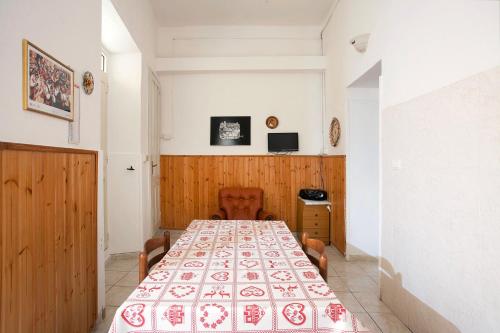 a room with a long table with a red and white blanket at Davi in Cagliari
