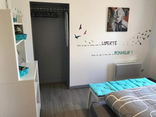 a bedroom with a bed and birds on the wall at Les Lodges du Canal Vue sur le canal in Rogny
