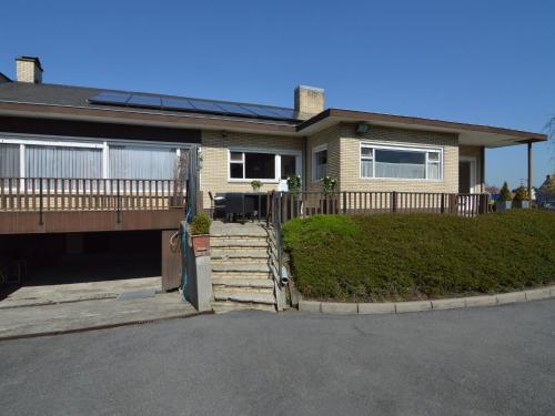 a house with a porch and a driveway at Spacious holiday home in Ruiselede with a garden in Ruiselede