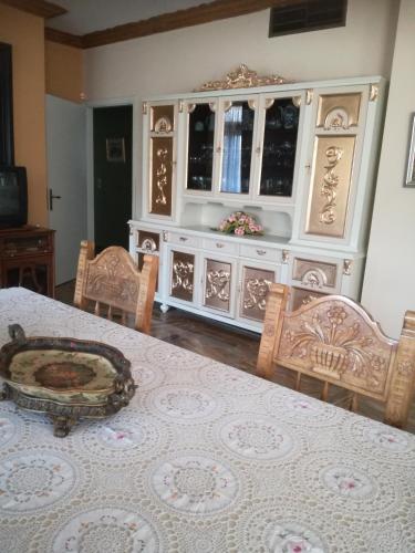 a dining room with a table and chairs and a hutch at Castle By The Sea in Artemida