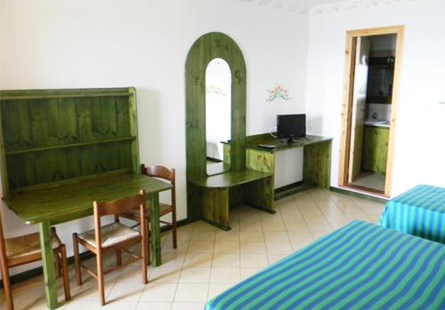 a room with a desk and a table and a mirror at Residence Letojanni Taormina in Letojanni