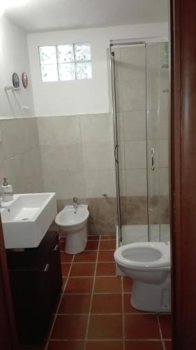a bathroom with a sink and a toilet and a shower at B&B Sa Serra in Stintino