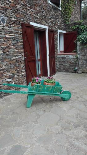 a green bench with flowers on it in front of a building at B&B Sa Serra in Stintino