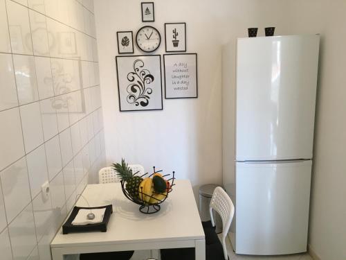 a kitchen with a table with a white refrigerator at Luigi apartments in Dubrovnik