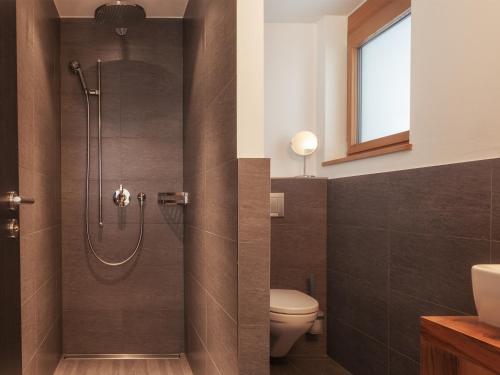 a bathroom with a shower and a toilet at Chalet Nepomuk in Zermatt