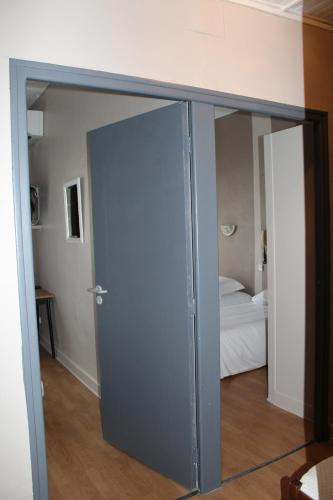 a sliding glass door in a room with a bedroom at Les Glycines in Remoulins