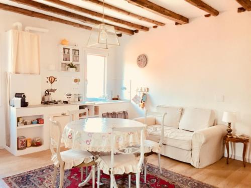 a kitchen and living room with a table and chairs at Casa Mongolfiere Venezia in Venice