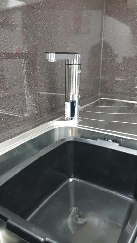 a kitchen sink with a faucet on top of it at Somerset House Apartments in Blackpool