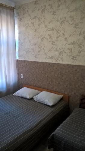 a bed with two pillows on it in a bedroom at Griboedova 110 in Saint Petersburg