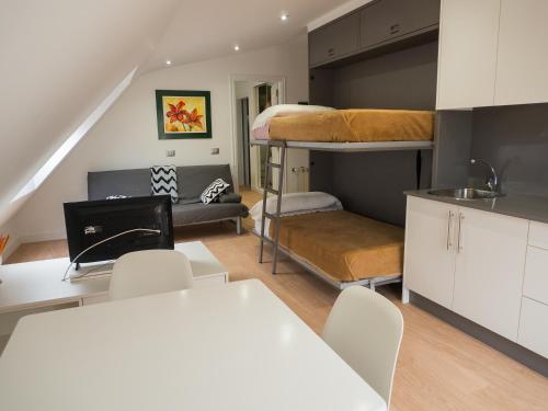 a kitchen and a living room with bunk beds at Hotel Vila da Guarda in A Guarda