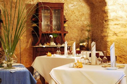 a group of tables with white table cloths at Casal Santa Eulalia in Can Picafort