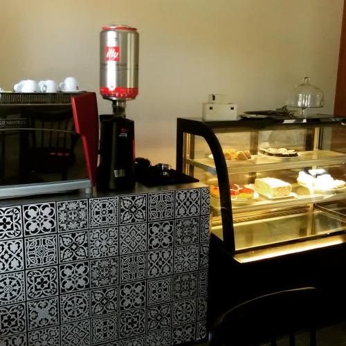 a counter with a glass case with food on it at Lagar Hotel Boutique in Molina