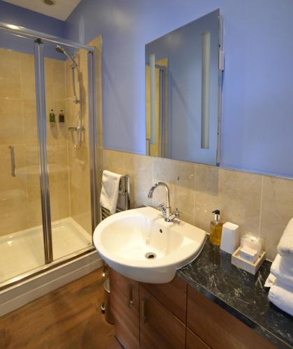 a bathroom with a sink and a shower at Glendon Bed and Breakfast in Matlock