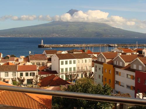a view of a city with a bridge and the ocean at Apartamentos Turisticos Verdemar in Horta
