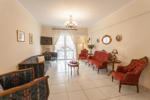 a living room with couches and chairs at Athens charming flat 10 min away from Acropolis by metro in Athens