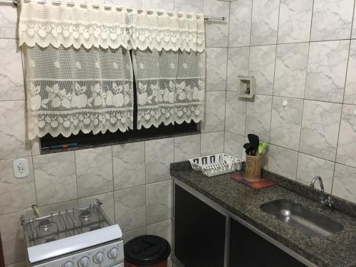 a small kitchen with a sink and a window at Apartamento Vista da Montanha in Nova Friburgo