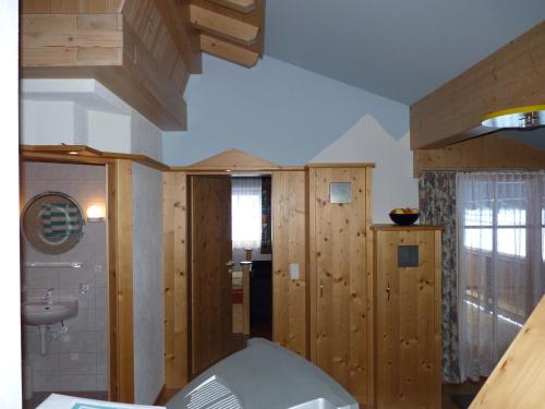 a bathroom with wooden walls and a sink at Conny's Ferienwohnungen in Gschnitz