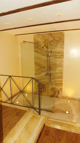 a bathroom with a shower with a glass wall at Residenze Gregoriane - Residenza d'Epoca in Tivoli