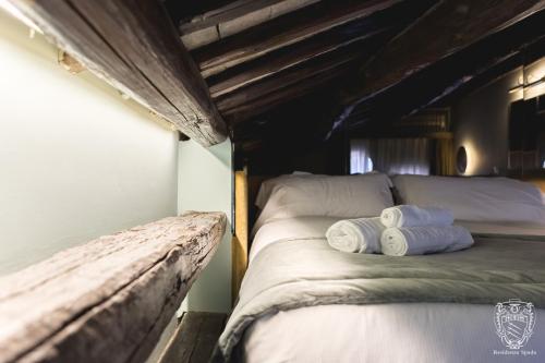 a bed in a room with two pillows on it at Residenza Spada in Rome