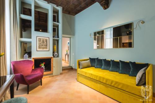 a living room with a yellow couch and a fireplace at Residenza Spada in Rome