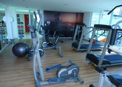 a gym with a bunch of exercise equipment in it at Atlantis Residence in Vitória