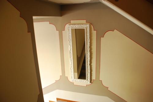 a mirror on the side of a stairway with a light at Hotel Andreis in Cavaion Veronese