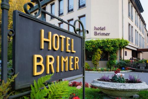 a hotel sign in front of a building at Hotel Brimer in Grundhof