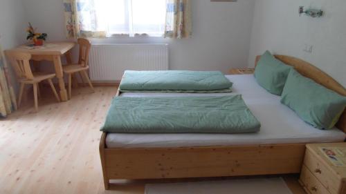 a small bedroom with two beds and a table at Luenerhof in Neustift im Stubaital