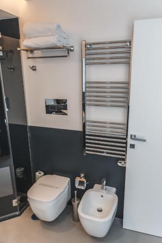 a bathroom with a white toilet and a sink at Relais Della Porta in Naples