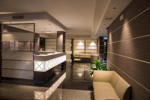 a lobby with a couch and chairs in a building at Hotel Imperial in San Benedetto del Tronto