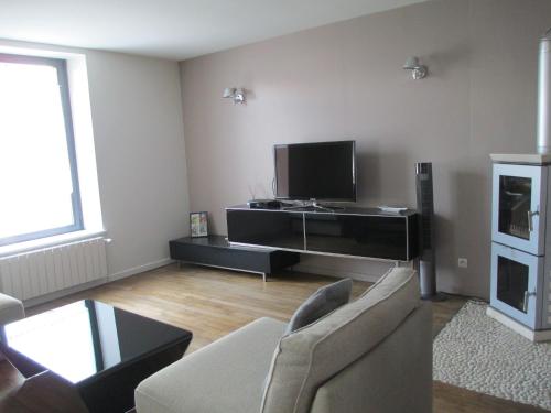 ein Wohnzimmer mit einem Sofa und einem Flachbild-TV in der Unterkunft Chambre d'hôtes B&B in Moncel-sur-Seille