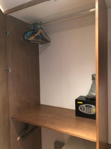 a room with a wooden shelf with a radio on it at Romantic Bungalow in Notting Hill in London