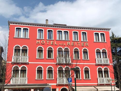 a red building with the hotel rector on it at New Reiter Hotel in Venice-Lido
