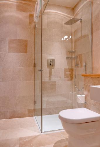 a bathroom with a shower and a toilet at Southernhay House Hotel in Exeter