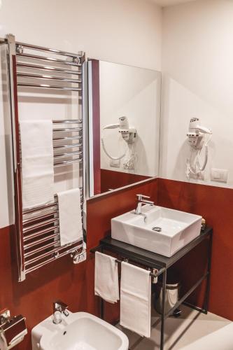 a bathroom with a sink and a mirror at Relais Della Porta in Naples