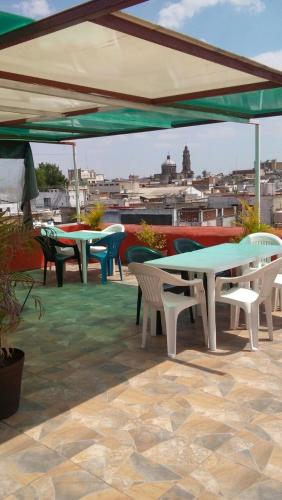 a group of tables and chairs on a roof at Casa Santuario Hotel Boutique in Guadalajara
