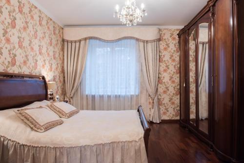 a bedroom with a large bed and a window at Classy apartment in good neighbourhood in Riga