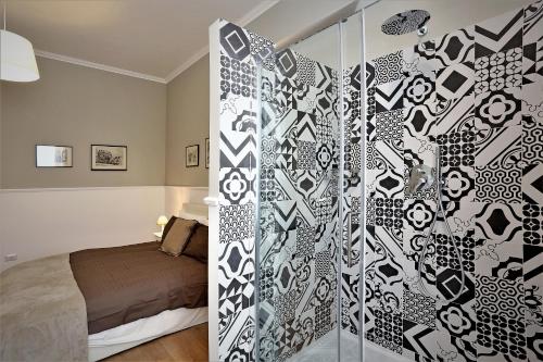 a bedroom with a bed and a glass wall at romantica guest house in Rome