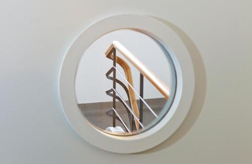 a circular mirror on a wall with a staircase at Hotel Seehof in Zurich